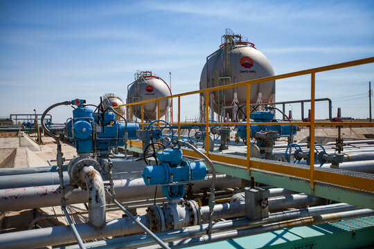Zhanazhol, Aktobe region, Kazakhstan - May 04, 2012: Sphere gas storage tanks for liquefied petroleum (natural) gas LPG, LNG. CNPC company. Oil refinery plant in desert. Control valves.