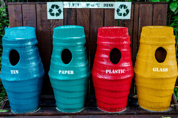 Metal garbage containers for separate collection of garbage on tropical island, concept of ecology...