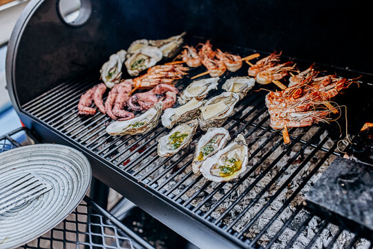 Seafood BBQ  barbecue. Collection of octopus, oysters, clam, tiger shrimps grilled on grill