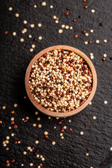 mixed raw quinoa in bowls on wooden background. Healthy and gluten free food. Origin Peru, vertical image. top view. place for text