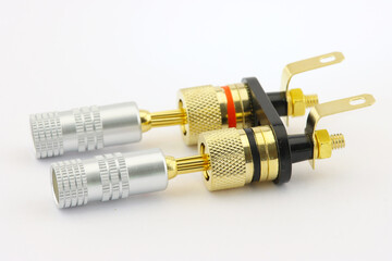 Connectors for connecting acoustic cables to audio amplifiers close-up on a white background.