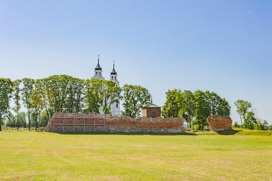 Ruines of the medieval Luzen castle, built by the Livonian knight order, in nowadays Ludza, Latgalia, Latvia. Red brick walls, blue sky, green grass