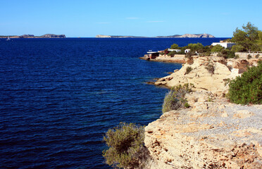 Fototapeta na wymiar rocky coast on an intense blue sea in ibiza