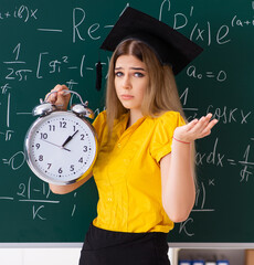 The young female student in front of the chalkboard