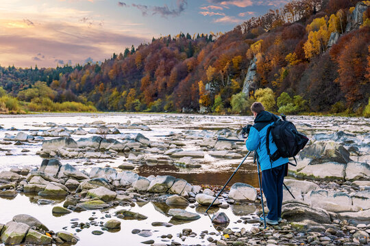 Photographer takes pictures of autumn landscape in highland