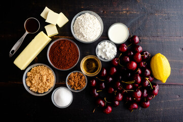 Fototapeta na wymiar Ingredients for Bourbon Cherry Chocolate Galette: Fresh cherries, cocoa powder, and other ingredients for baking a dessert