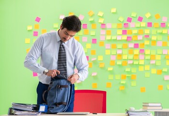 Man in the office with many conflicting priorities