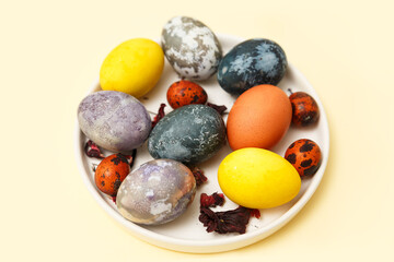 Easter, colored Easter eggs on a yellow background. Natural dyes for Easter eggs turmeric, onion, hibiscus