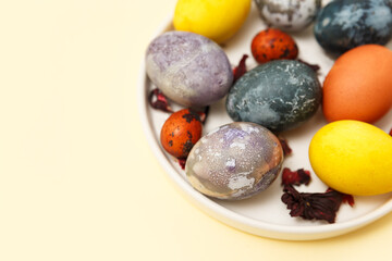 Beautiful Easter eggs with a marbled stone effect, blue violet, yellow on a colored background. Eco-friendly dyes for Easter eggs. Lots of room for copying. 