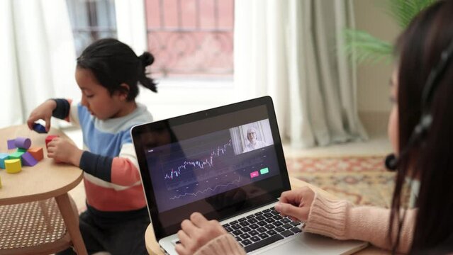 Trader latin mother working with kid at home while studying stock market on streaming video lesson - Blockchain analysis concept
