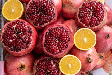 ripe red pomegranates and oranges ready to be juiced