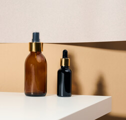 brown glass bottle with pipette stands on a white table. Cosmetics SPA branding. Packaging for gel, serum, advertising and product promotion, mock up