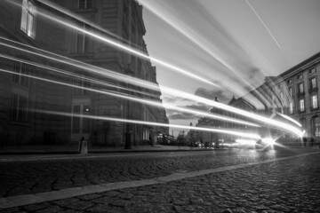 Light trails from cars and motorbikes on a busy boulevard in Paris France in black and white