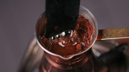 Mixing ground coffee in cezve - Traditional Turkish coffee maker