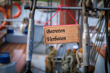 on a wooden sign is written in german: Betreten verboten