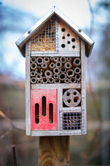 in a garden there is a small insect hotel
