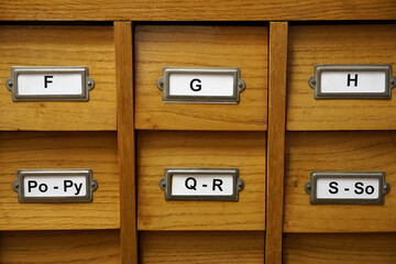 Archival or library wooden catalog with letter marks on document sorting compartments