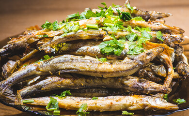Fried fish capelin, assorted seaweed salad and sweet potato fries, selective focus