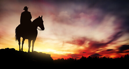 Cowboy on a horse at sunset