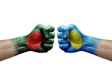 Two hands punch to each others on white background. Country flags painted fists, conflict crisis concept between bangladesh and palau