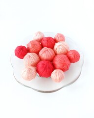 Red yarn on a glass round plate.