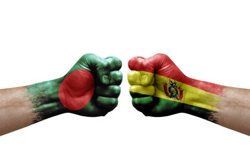 Two hands punch to each others on white background. Country flags painted fists, conflict crisis concept between bangladesh and bolivia