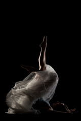 ballerina with a white dress and black top posing on black background. side lit silhouette. © Nikola Spasenoski