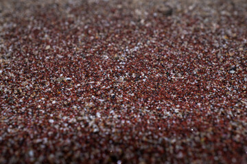 Texture of dry red clay with stones close-up