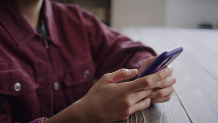 A young lady is watching something on the phone