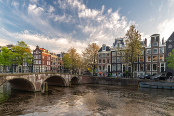 Amsterdam Netherlands, sunset city skyline of Dutch house at canal waterfront