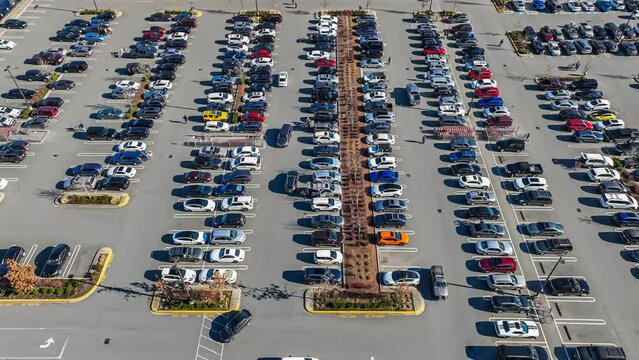 4k timelapse video clip of a busy shopping mall parking lot with crowds of people arriving and leaving on a sunny day