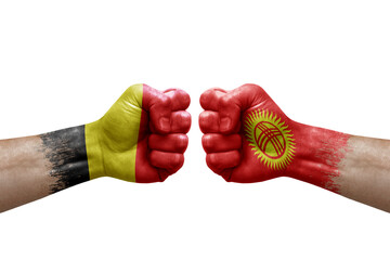 Two hands punch to each others on white background. Country flags painted fists, conflict crisis concept between belgium and kyrgyzstan