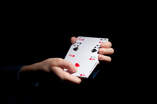 human hands shuffling deck of cards on the dark background