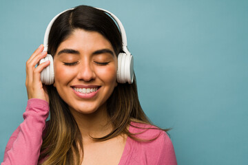 Happy woman smiling while listening music
