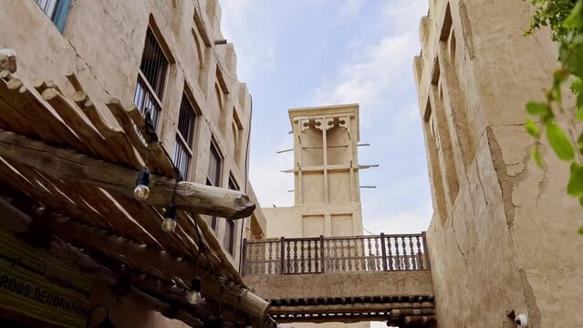 View From Alleyway Of Wind Tower On Top Of A Residential Building In Al Fahidi Historical Neighborhood In Dubai, UAE. low angle, dolly-in
