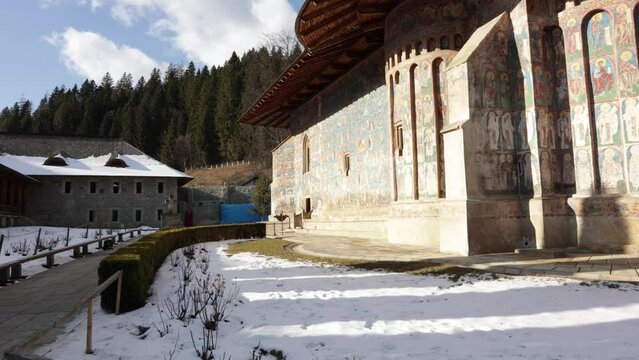 Famous Voronet Monastery In Suceava County, Romania. Known For Its Intense Blue Exterior Frescoes. pan right