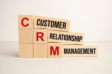 words crm in wooden alphabet letters on a bright yellow background with copy space, business concept. CRM - Customer Relationship Management.