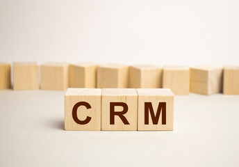 words crm in wooden alphabet letters on a bright yellow background with copy space, business concept. CRM - Customer Relationship Management.