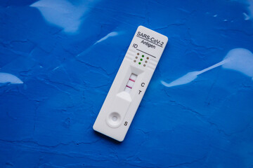 SARS-CoV-2 rapid antigen test with two colored lines - positive result of coronavirus infection © Fotokon