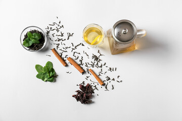 Obraz na płótnie Canvas Composition of teapot and glass with tasty tea on light background