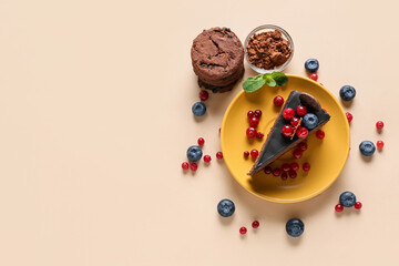 Plate with delicious piece of chocolate cake, cookies and berries on light background