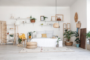 Stylish interior of modern bedroom with houseplants