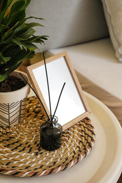 Aroma reed diffuser with photo frame on table in bedroom