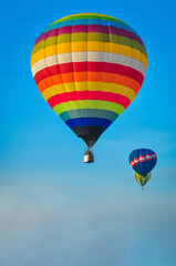 Beautiful colorful hot air balloon flying on the clear blue sky background.