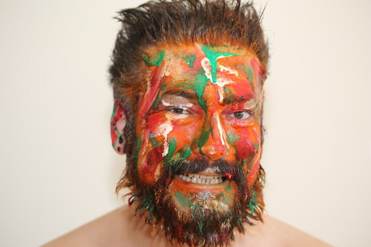 Portrait of a man colorful make up on his face different emotion