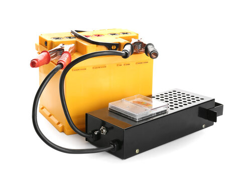 Modern car battery with tester on white background