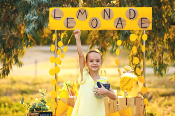 Cute girl selling lemonade in park