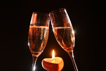 two glasses of champagne with candle light
