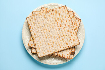 Plate with Jewish flatbread for Passover on color background
