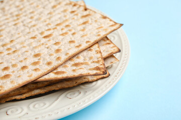 Plate with Jewish flatbread for Passover on color background, closeup